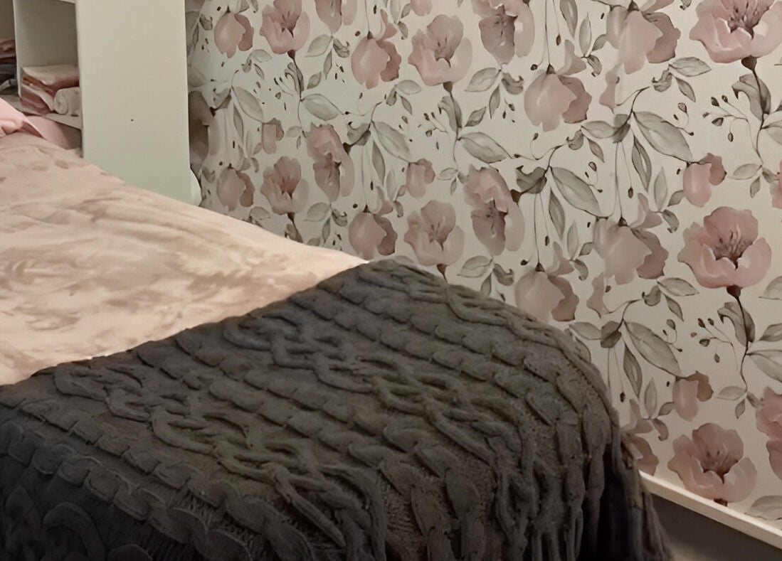 Cozy treatment room at Amabilia Beauty in Charmhaven, New South Wales, AU, with floral wallpaper and plush bedding.