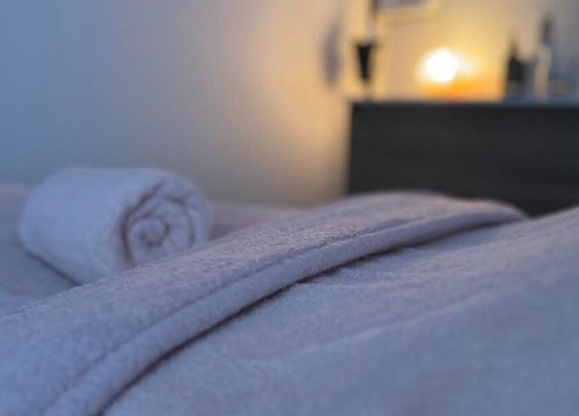 Peaceful spa setting with soft lighting and fresh towels at Amabilia Beauty, Charmhaven, New South Wales, AU.