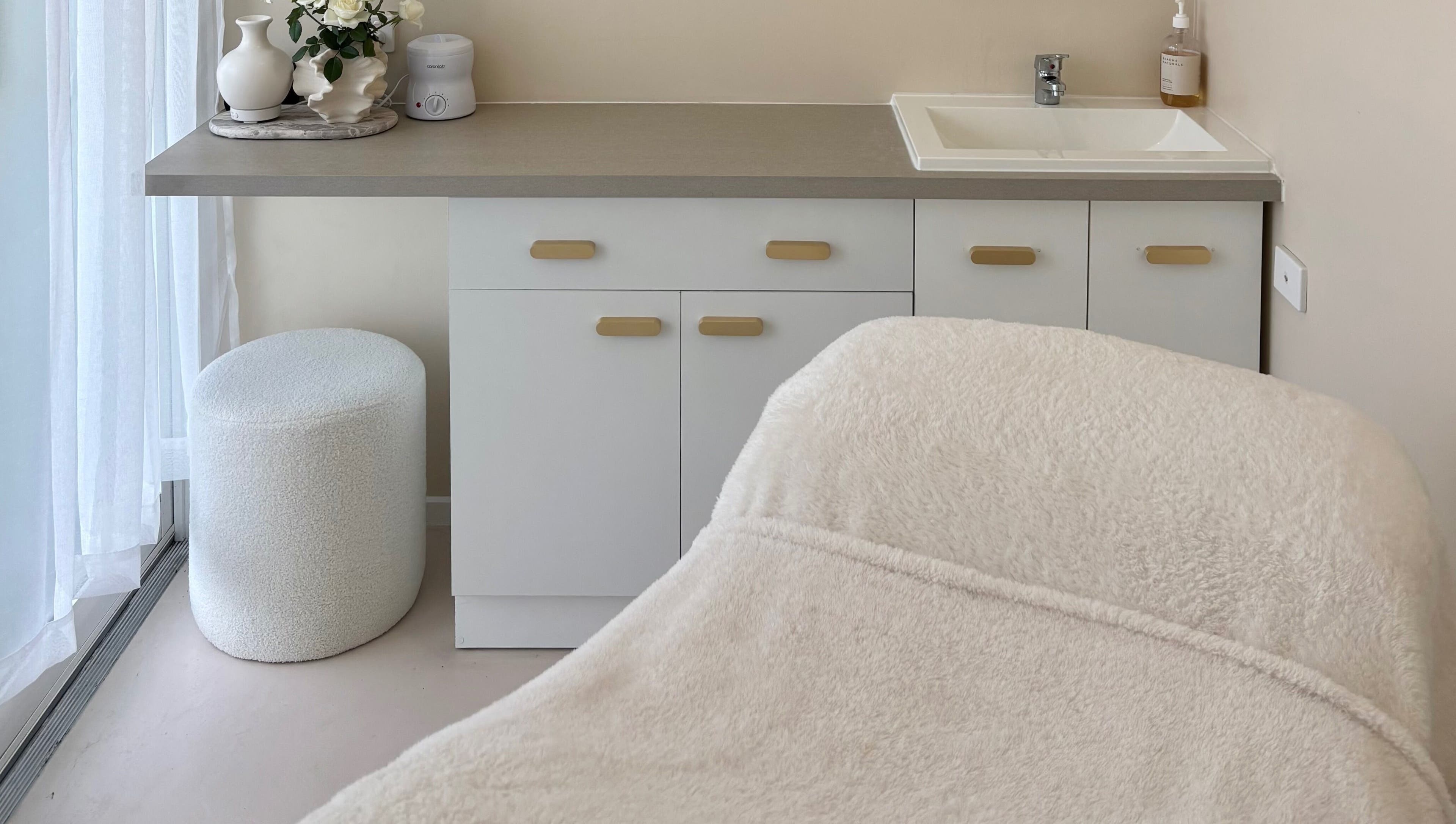Cozy treatment room at Base Beauty Studio, Burleigh Waters, Queensland, AU featuring a plush massage table.