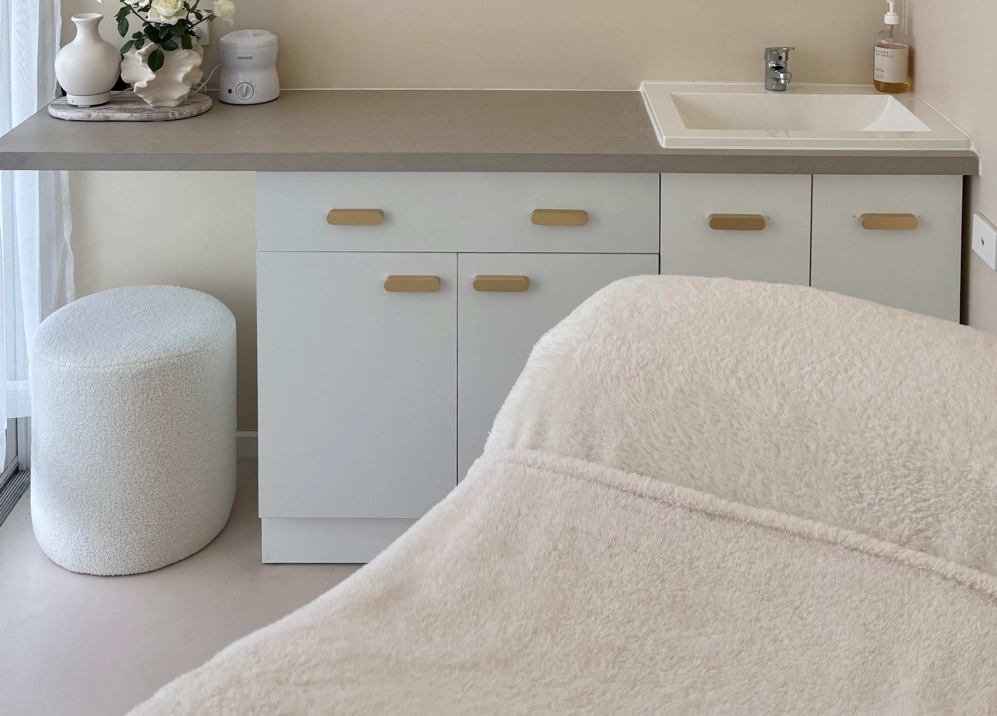Cozy treatment room at Base Beauty Studio, Burleigh Waters, Queensland, AU featuring a plush massage table.