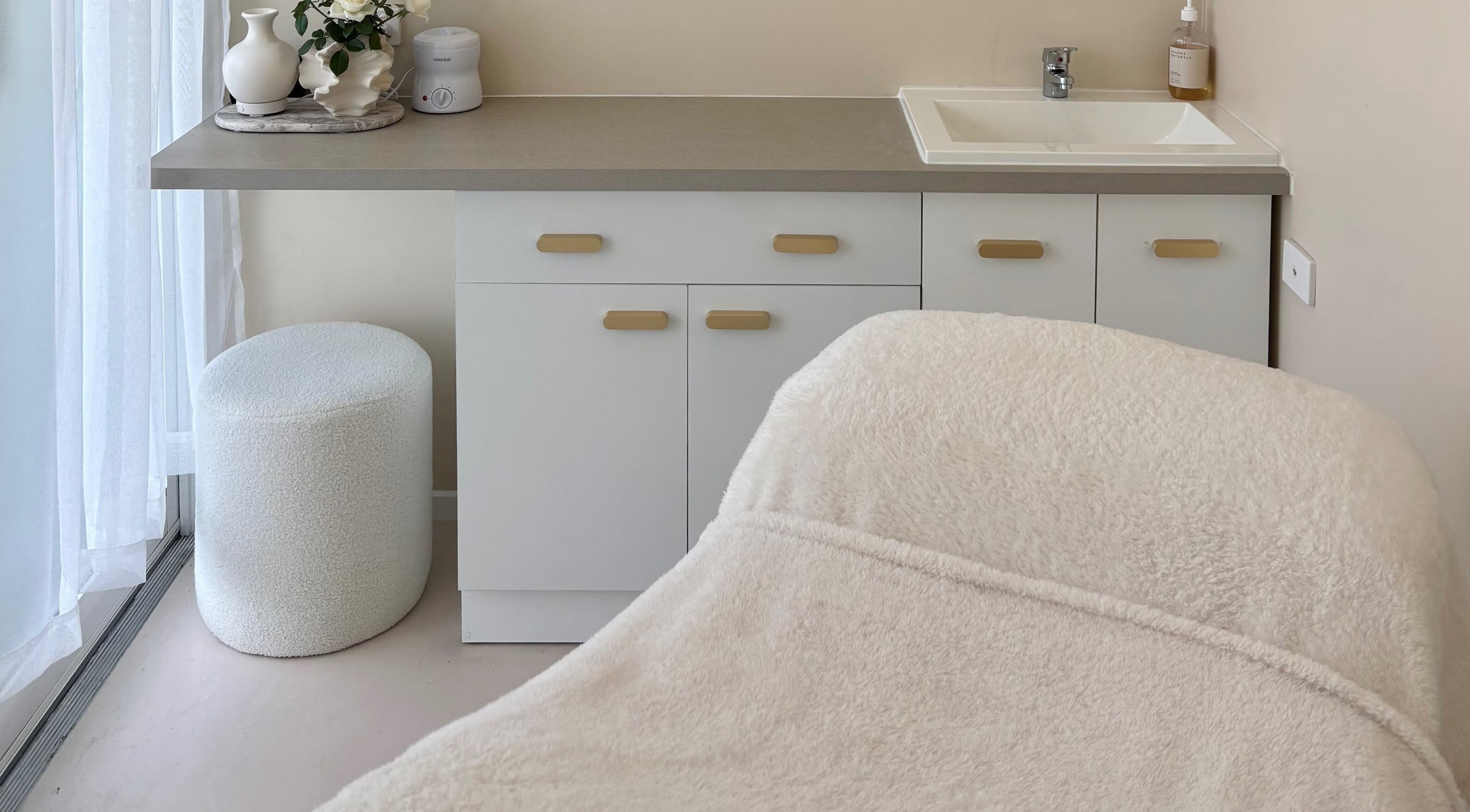 Cozy treatment room at Base Beauty Studio, Burleigh Waters, Queensland, AU featuring a plush massage table.