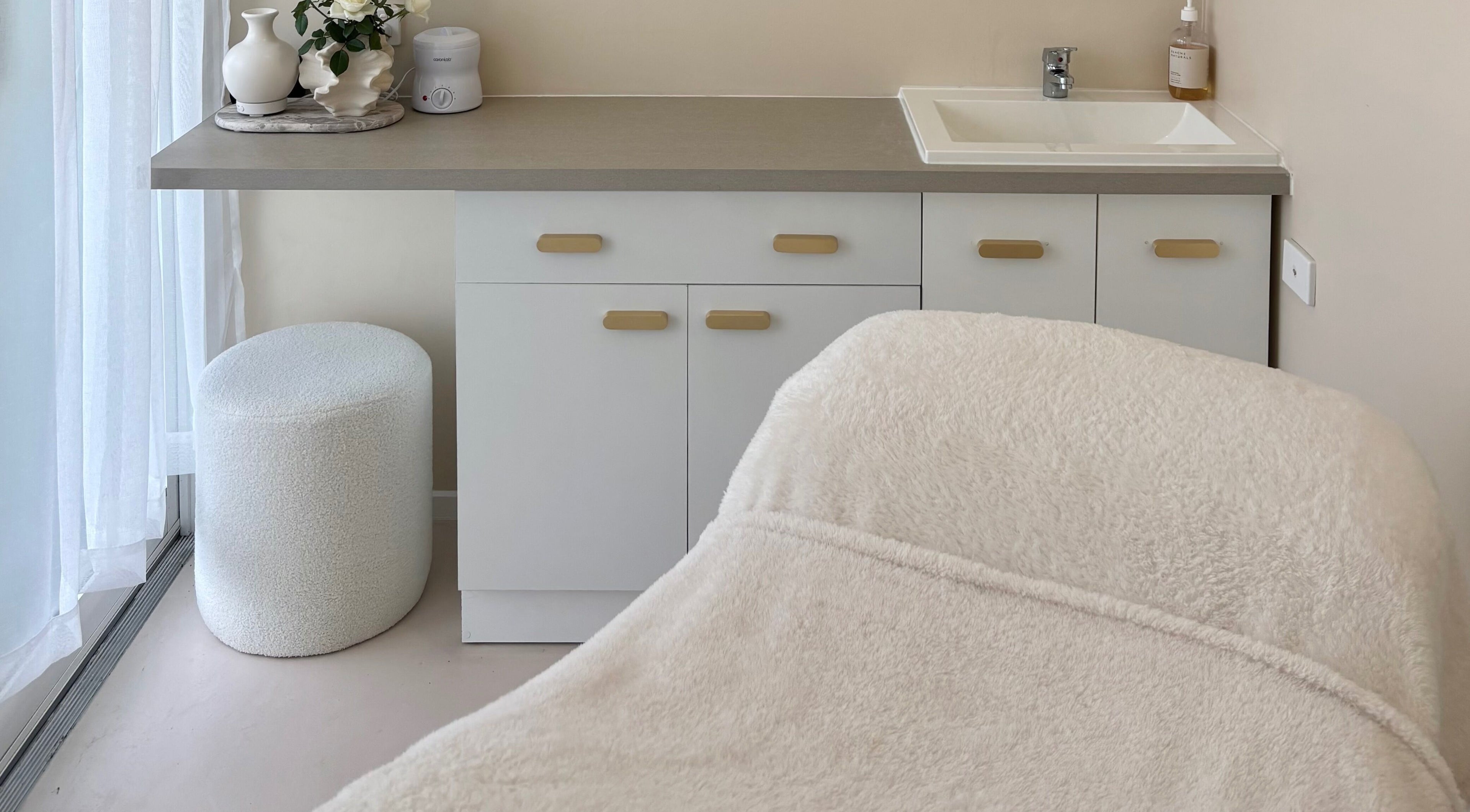 Cozy treatment room at Base Beauty Studio, Burleigh Waters, Queensland, AU featuring a plush massage table.