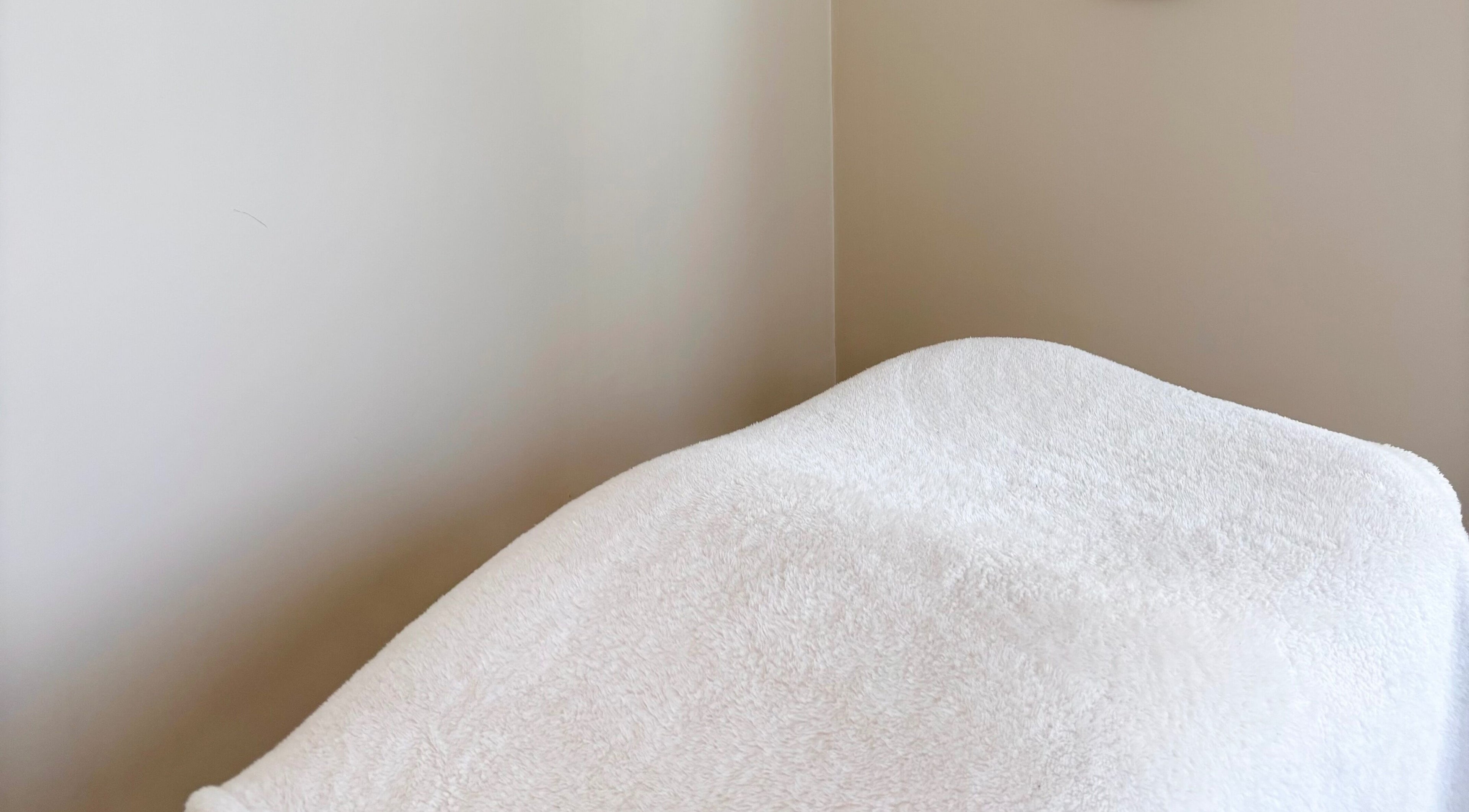 Cozy treatment bed at Base Beauty Studio, Burleigh Waters, Queensland, AU for relaxation and wellness.