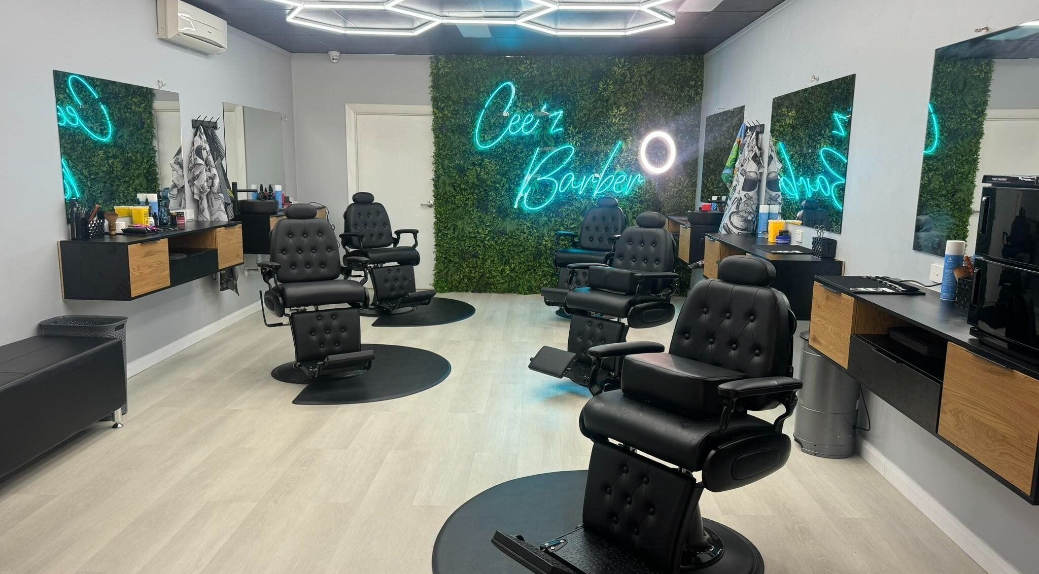Interior of Cee’z Barbershop Algester, Queensland, AU showing sleek barber chairs and vibrant decor.