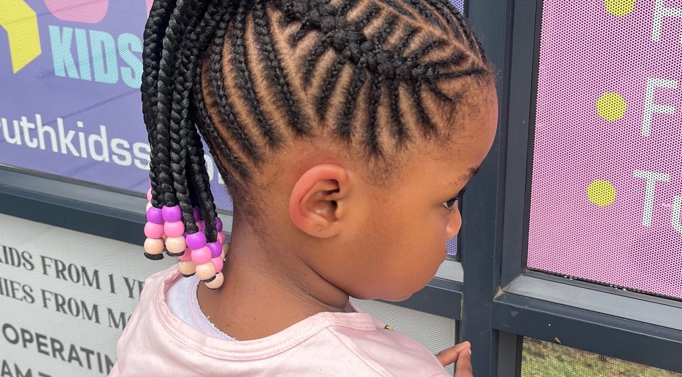 Creative braids with colorful beads at Ruth kids salon, located in Pretoria, Gauteng, ZA.