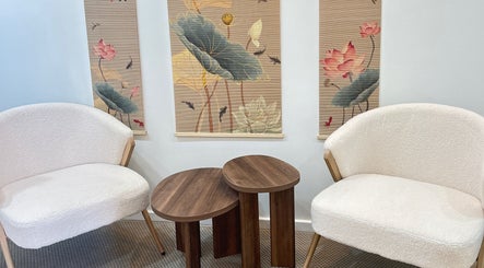 Elegant lounge at Lotus Crown Spa, Joondalup, WA, AU featuring plush chairs and lotus-themed decor.