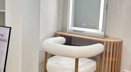 Elegant vanity setup at Lotus Crown Spa, Joondalup, WA, AU with chic chair and illuminated mirror.