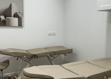 Modern treatment room at Lotus Crown Spa, Joondalup, WA with beige massage tables.