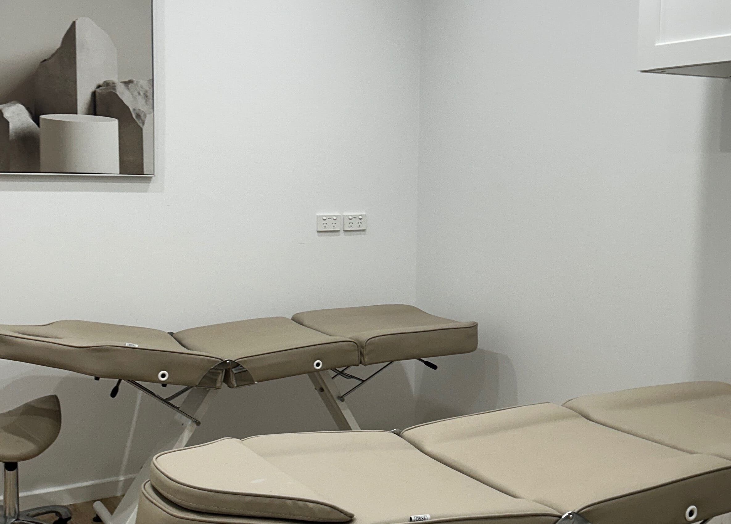 Modern treatment room at Lotus Crown Spa, Joondalup, WA with beige massage tables.