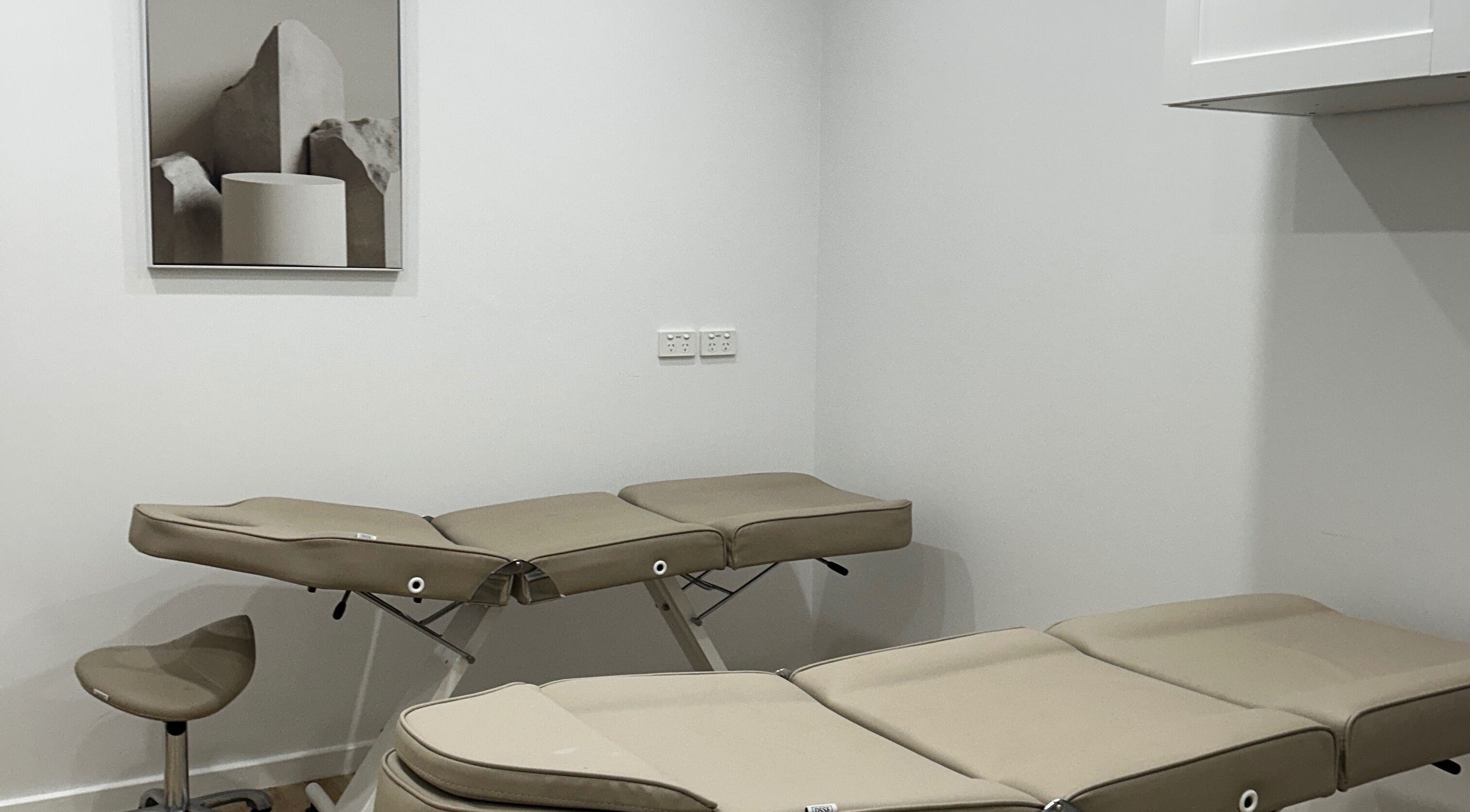 Modern treatment room at Lotus Crown Spa, Joondalup, WA with beige massage tables.
