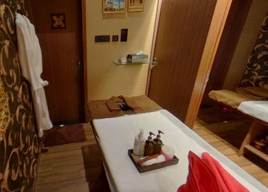 Tranquil massage room at Myo Thai Spa, Ooty, Tamil Nadu, IN, featuring a cozy setting with plush robes.