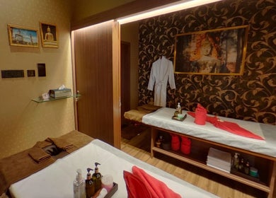Cozy spa treatment room at Myo Thai Spa, Ooty, Tamil Nadu, IN, showcasing serene ambiance and massage tables.
