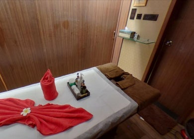 Massage table setup at Myo Thai Spa, Ooty, Tamil Nadu, IN with towels and aromatherapy oils.