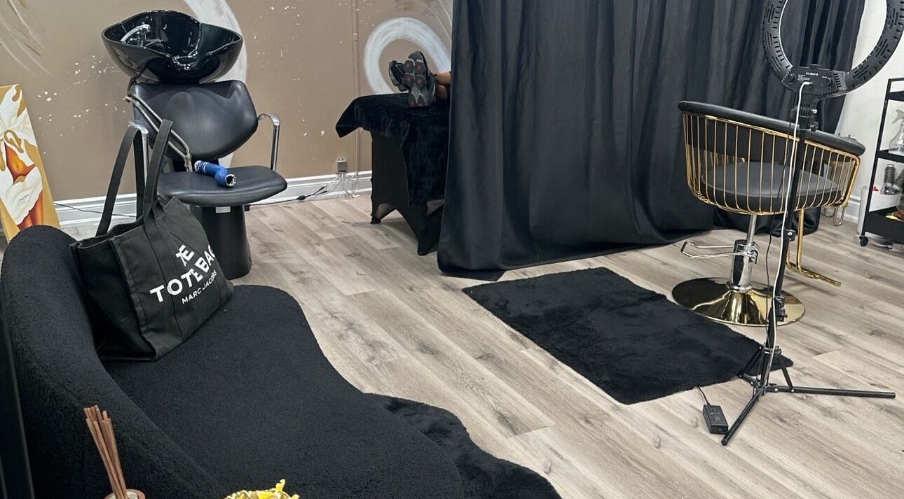Modern salon interior at Cassy Extensions in Vaughan, Ontario, CA with stylish black and gold decor.
