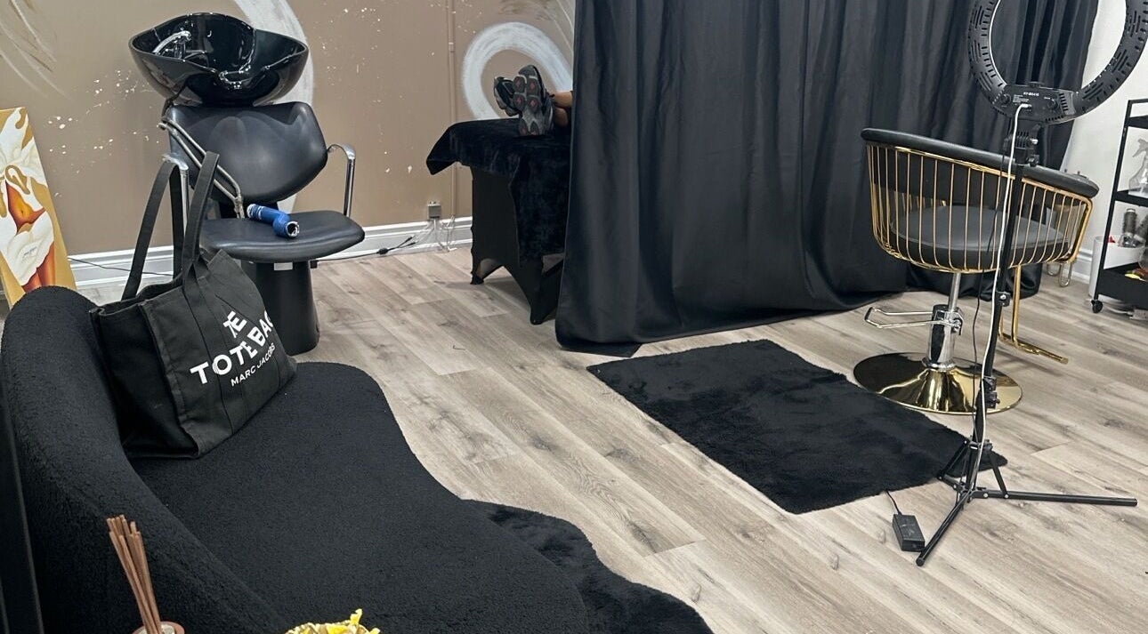 Modern salon interior at Cassy Extensions in Vaughan, Ontario, CA with stylish black and gold decor.