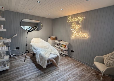 Calming beauty room at Beauty By Jaden, North Shields, England, GB, with cozy treatment bed and neon signage.