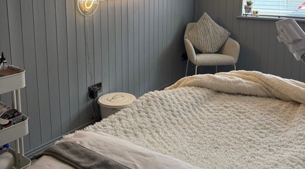 Inviting treatment room at Beauty By Jaden in North Shields, England, GB, featuring a plush bed and modern decor.