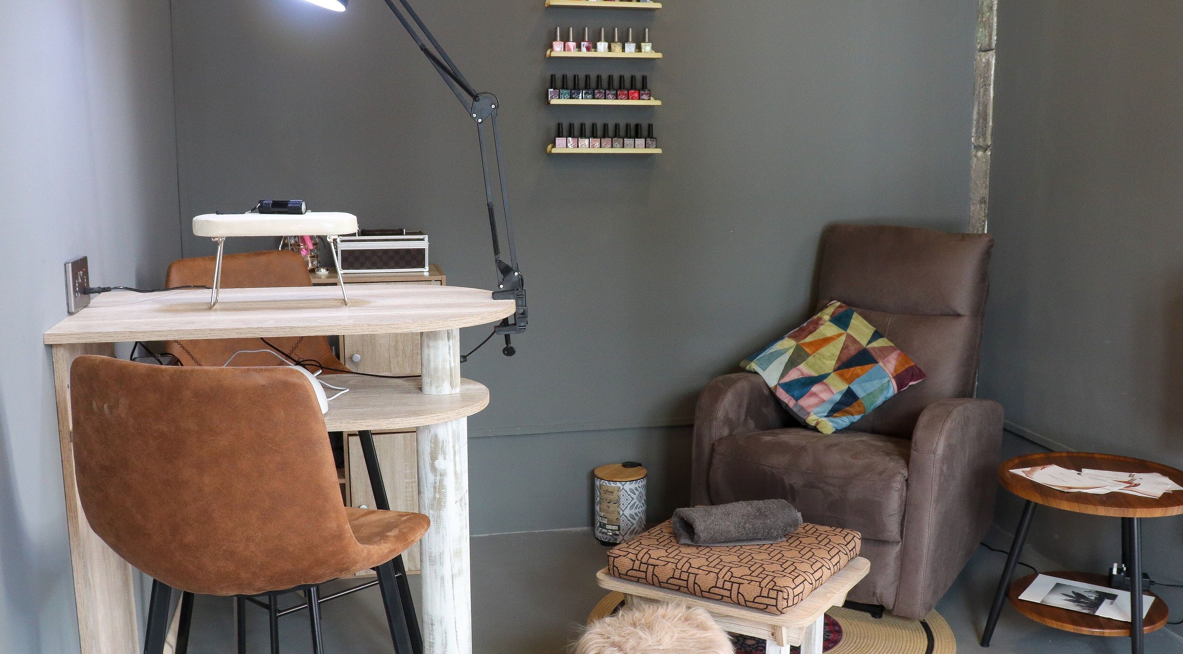Relaxing nail salon setup at Aesthe, Port Louis, Port Louis District, MU featuring comfy chairs and nail polish display.