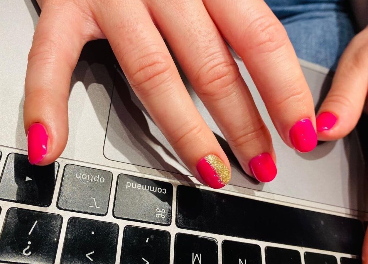 Vibrant pink nails on a keyboard at Naina Brow Bar, Dublin7, County Dublin, IE.