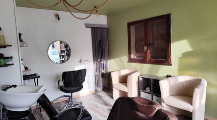 Intérieur chic de DC Coiffure à Saint-martin-de-valgalgues, Occitanie, FR avec fauteuils et miroir moderne.