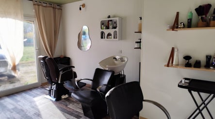 Intérieur chic de DC Coiffure à Saint-martin-de-valgalgues, Occitanie, FR avec fauteuils modernes et espace lumineux.