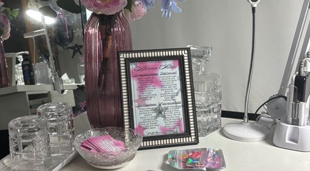 Elegant setup at Pretty Nuisance Artistry, Baldivis, WA with framed advice, vases, and beauty tools.