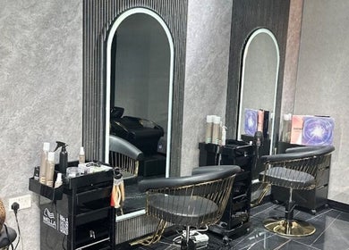 Chic interior of The Luxury Touch Beauty Salon, Dubai, Dubai, AE, featuring stylish chairs and mirrors.