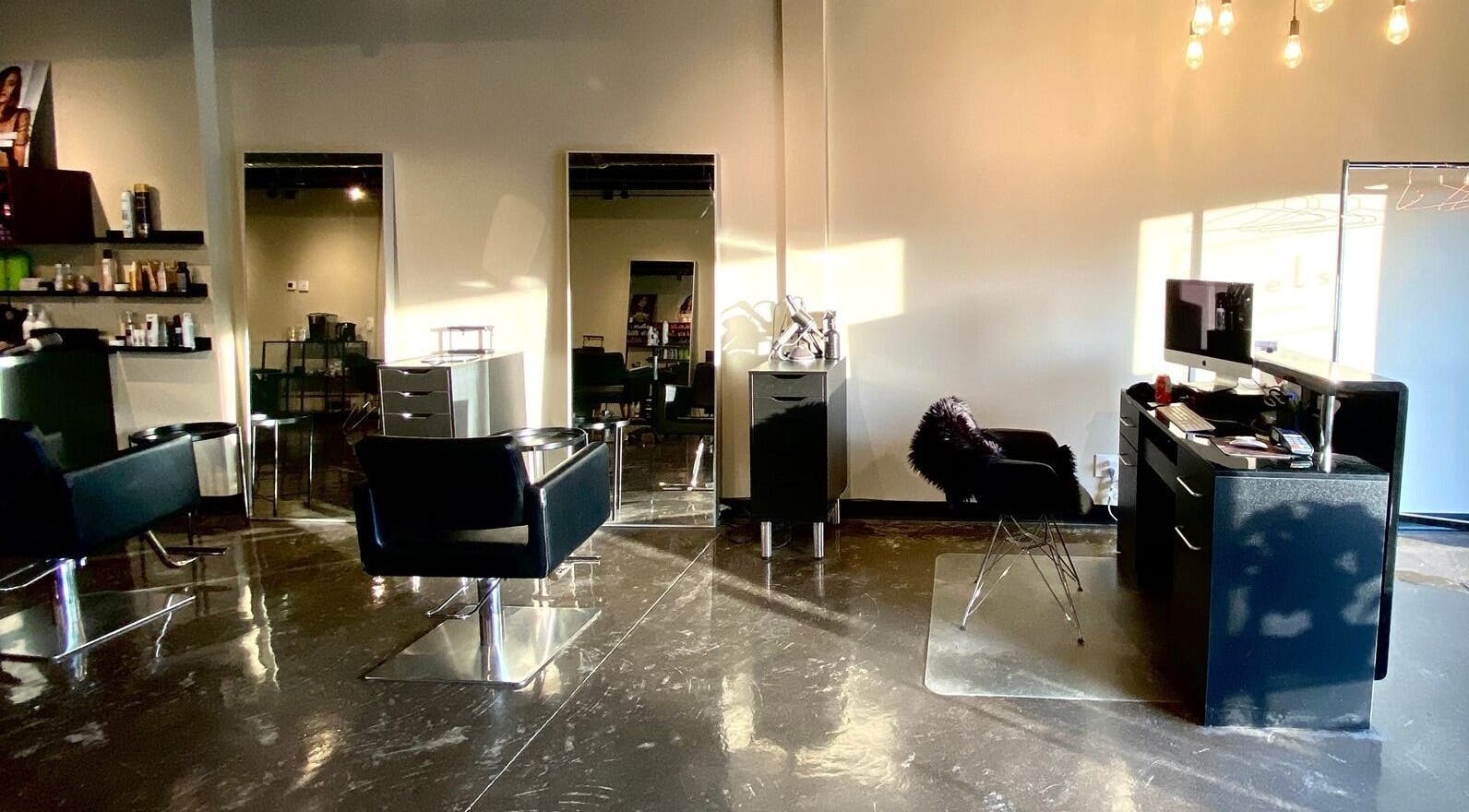 Modern interior of Levels Hair Salon in Hamilton, Ontario, CA with stylish chairs and ambient lighting.