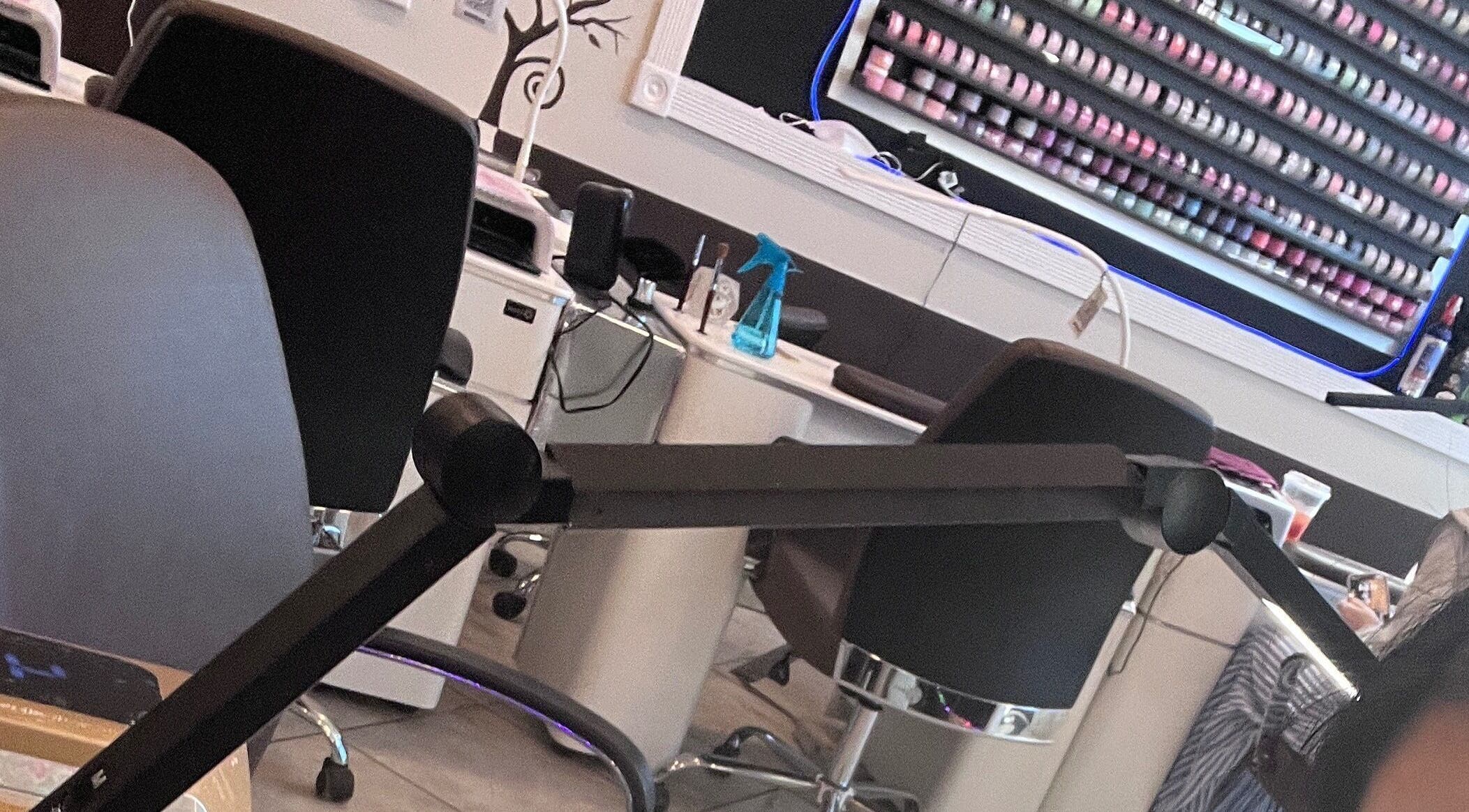 Sophisticated manicure setup at Kiwiinails Pro, Fenton, Michigan, US, showcasing polish selection and elegant seating.