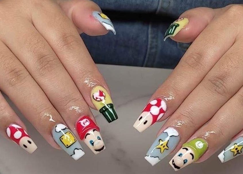 Colorful cartoon nail art at Kiwiinails Pro, Fenton, Michigan, US. Unique design with detailed character motifs.