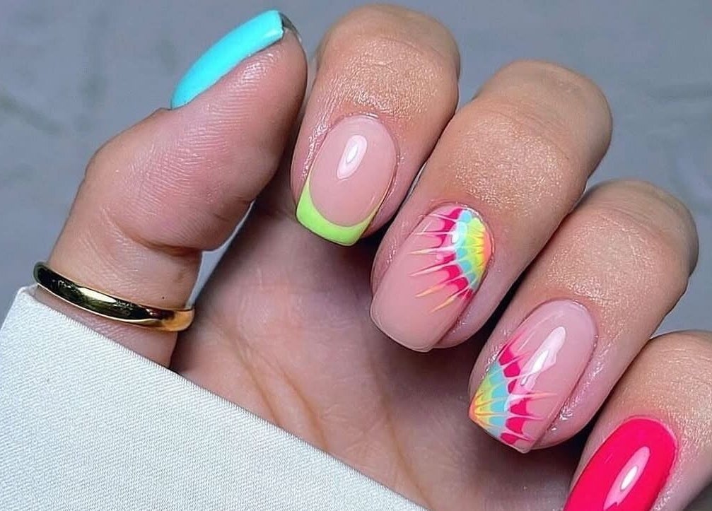 Colorful nail art at Kiwiinails Pro in Fenton, Michigan, US, featuring intricate designs and bold colors.