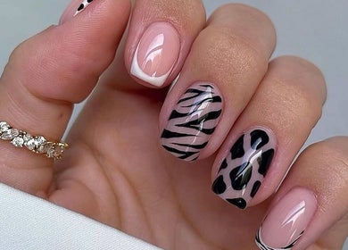 Stylish zebra nail art at Kiwiinails Pro, Fenton, Michigan, US, showcasing chic nail designs.
