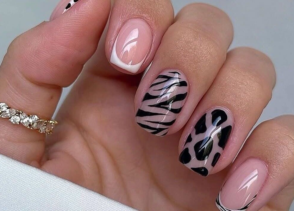 Stylish zebra nail art at Kiwiinails Pro, Fenton, Michigan, US, showcasing chic nail designs.