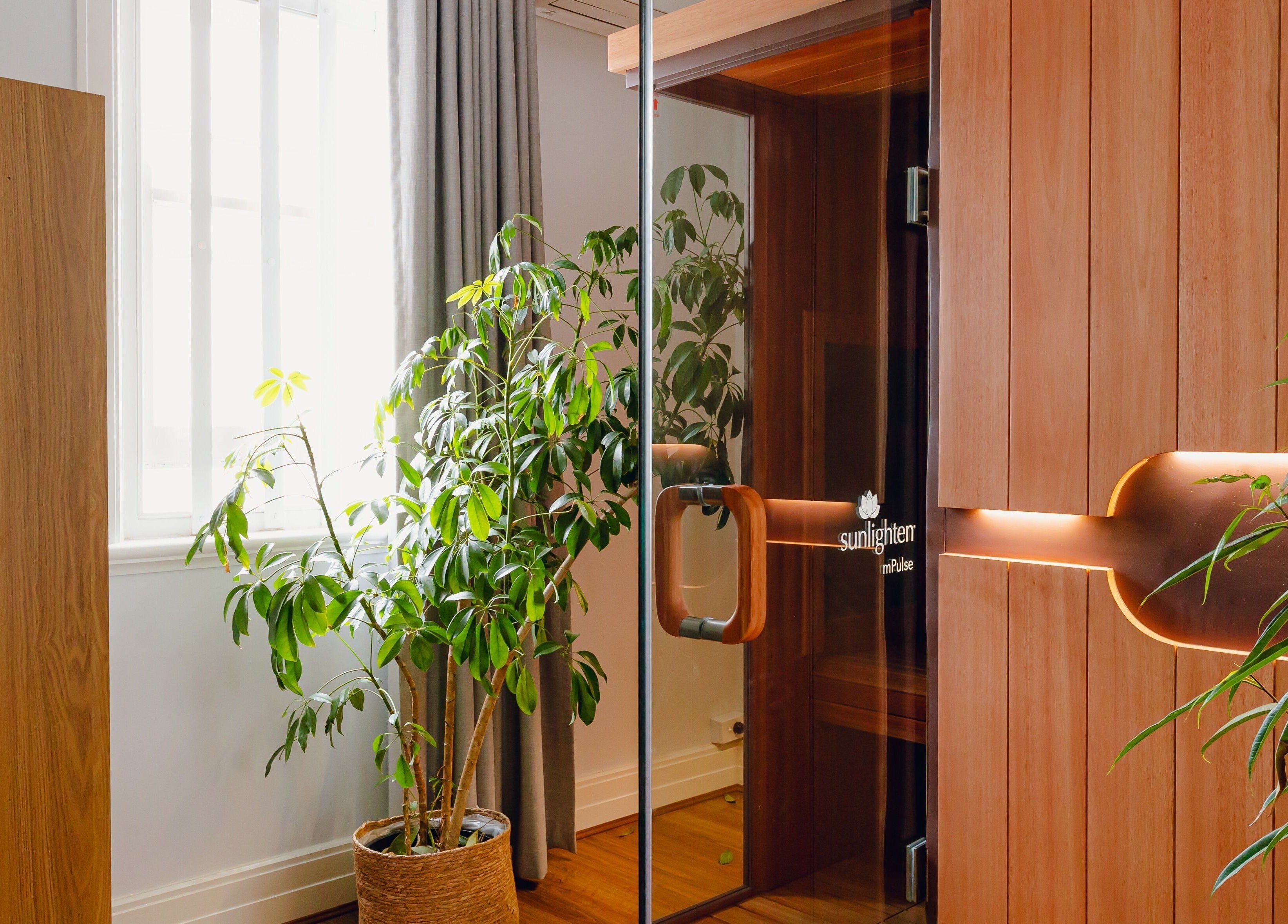 Cozy wooden sauna at Newleaf Spa, Melbourne, Victoria, AU, surrounded by lush greenery for relaxation.