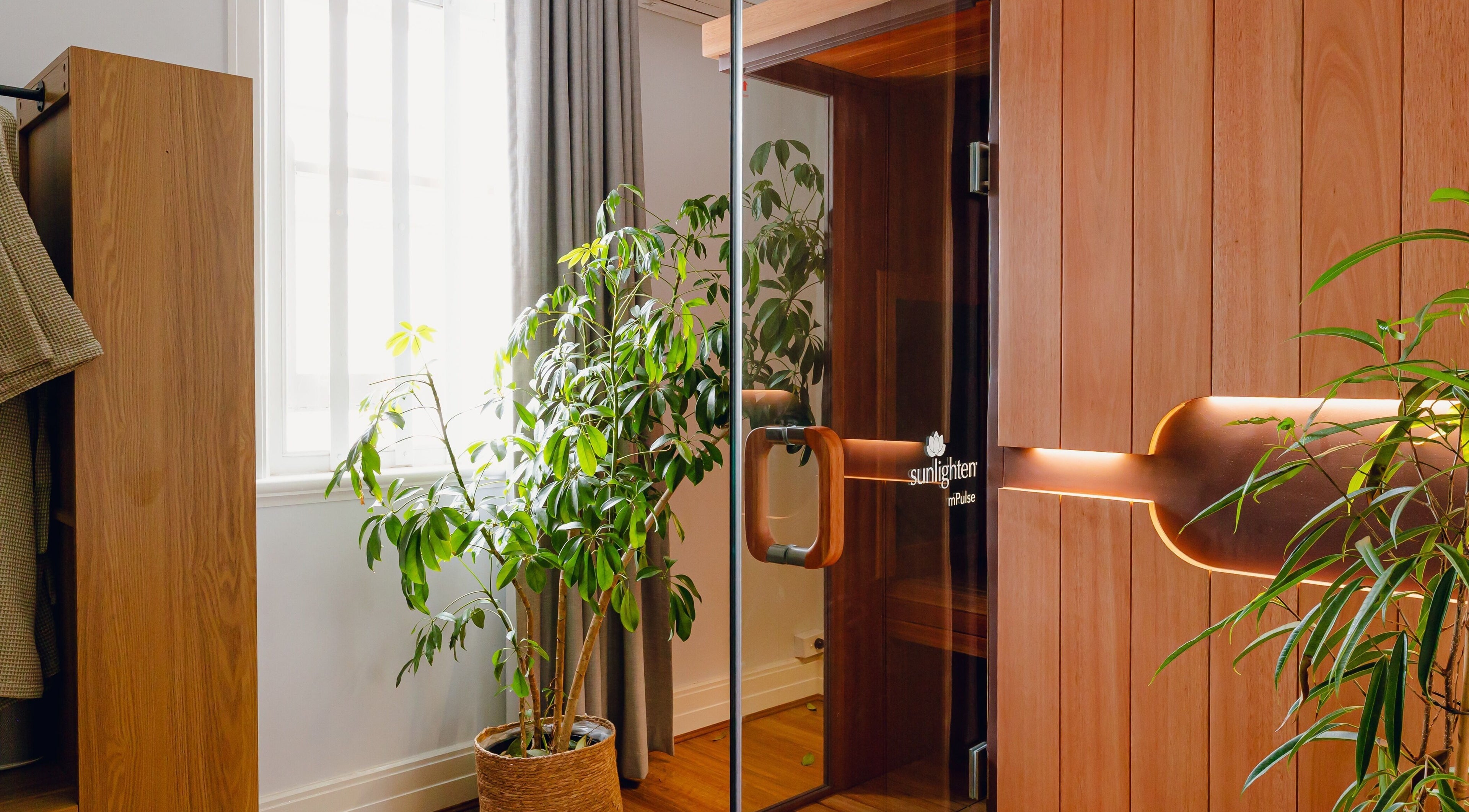 Cozy wooden sauna at Newleaf Spa, Melbourne, Victoria, AU, surrounded by lush greenery for relaxation.