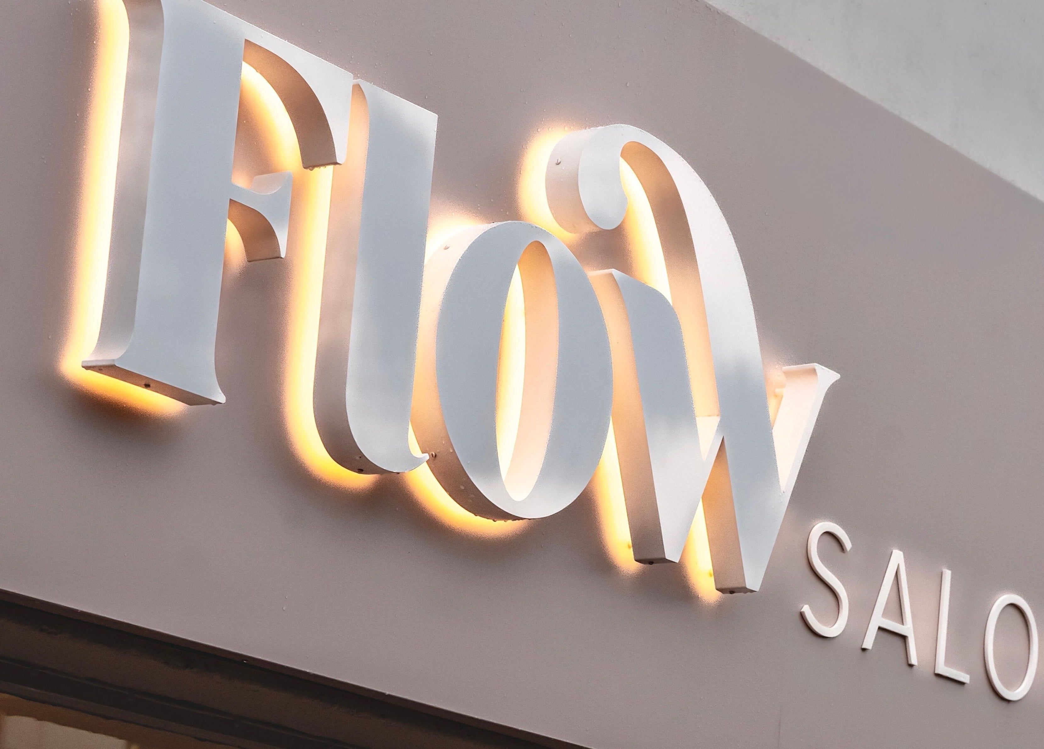 Illuminated Flow Salon sign in Royal Tunbridge Wells, England, GB.