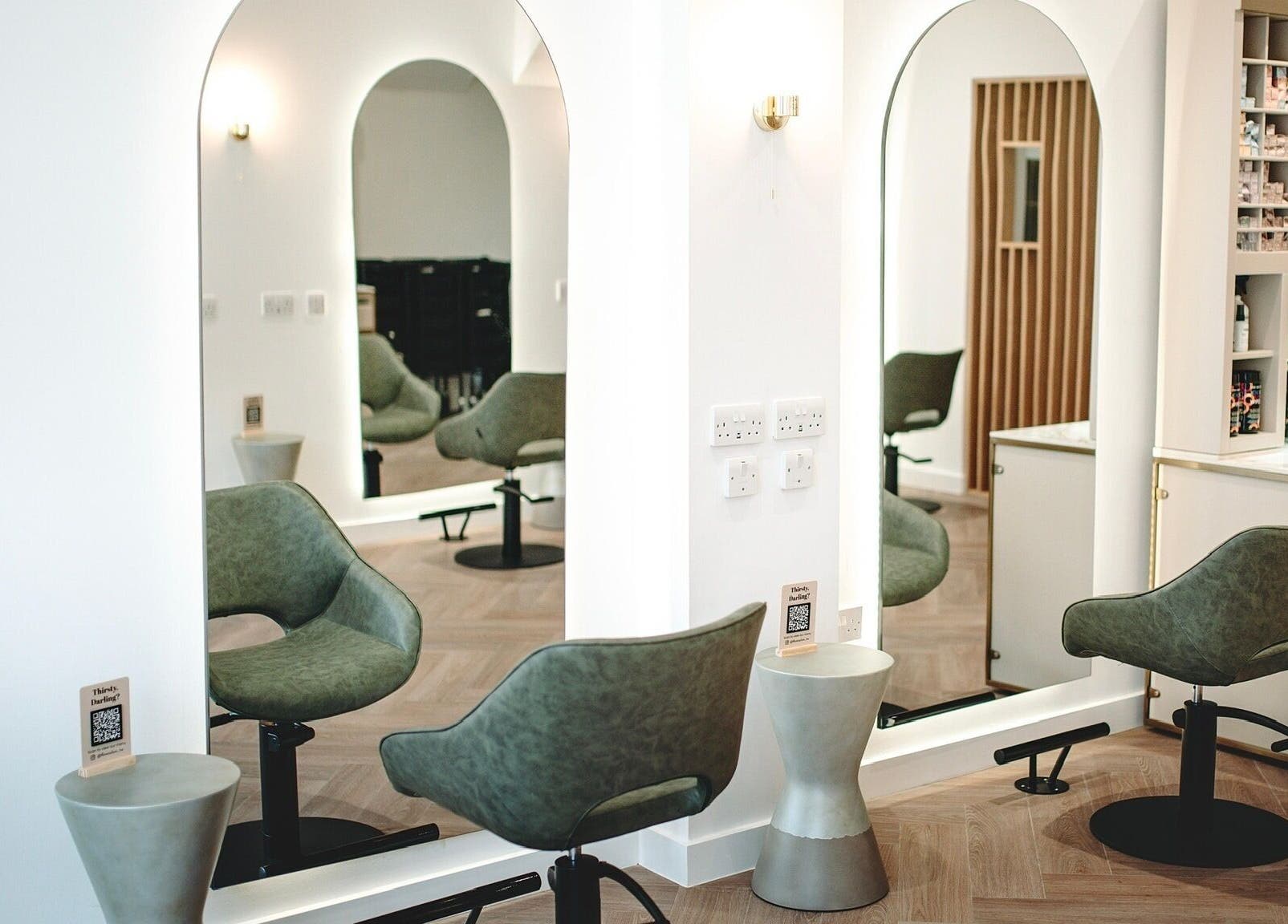 Elegant salon interior at Flow in Royal Tunbridge Wells, England, GB, featuring modern chairs and mirrors.