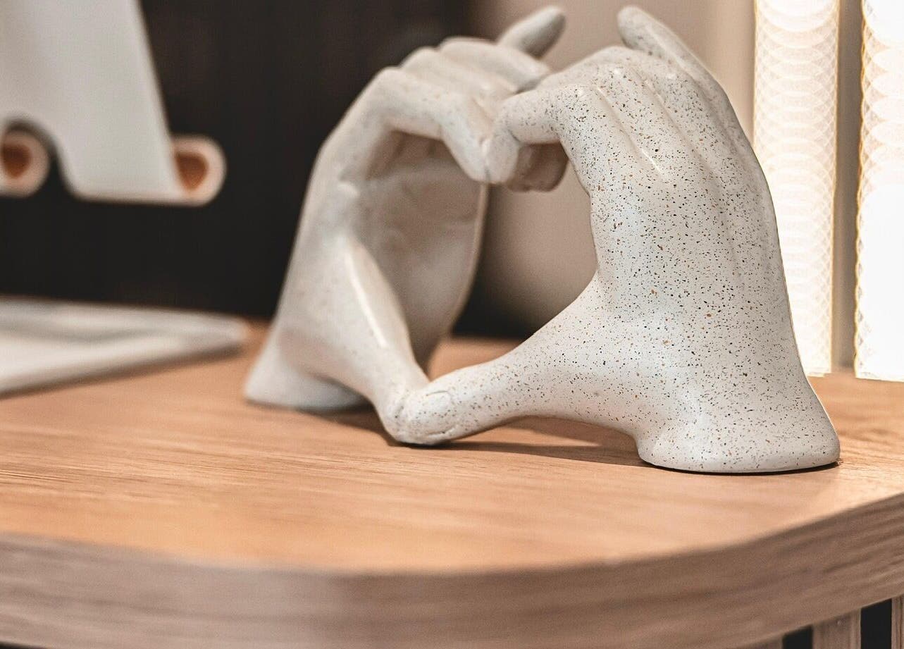 Elegant ceramic hands forming a heart at Flow, Royal Tunbridge Wells, England, GB. Perfect for wellness ambiance.