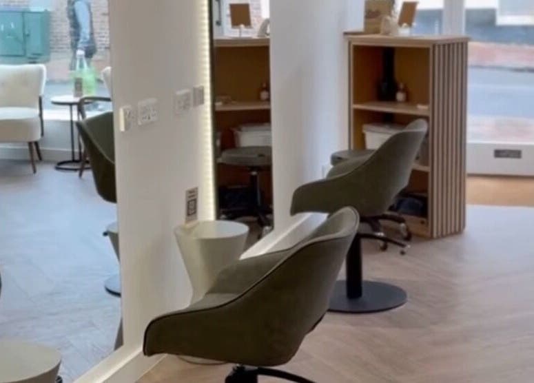 Elegant salon interior at Flow, Royal Tunbridge Wells, England, GB, featuring cozy chairs and ambient lighting.