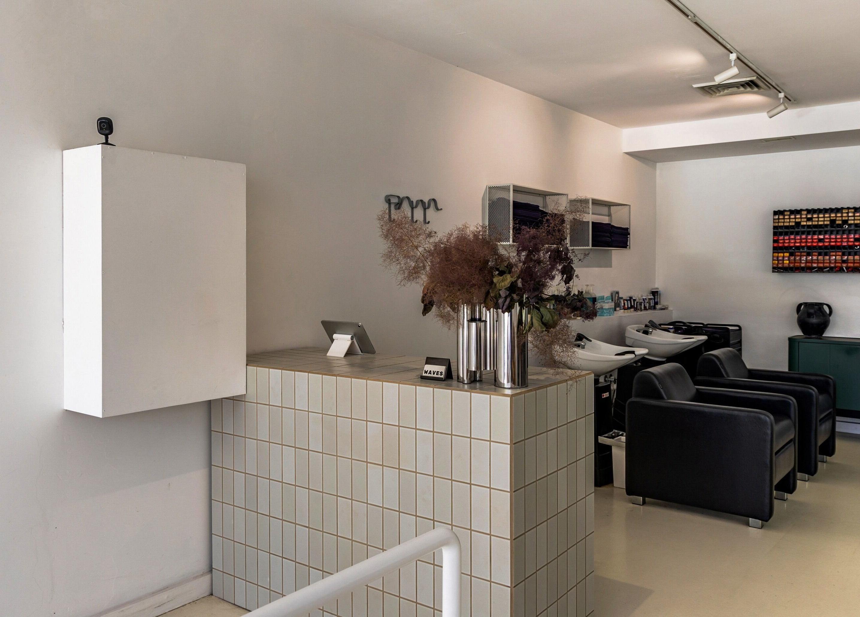 Modern salon interior at WAVES in Melbourne, Victoria, AU, featuring sleek chairs and stylish decor.