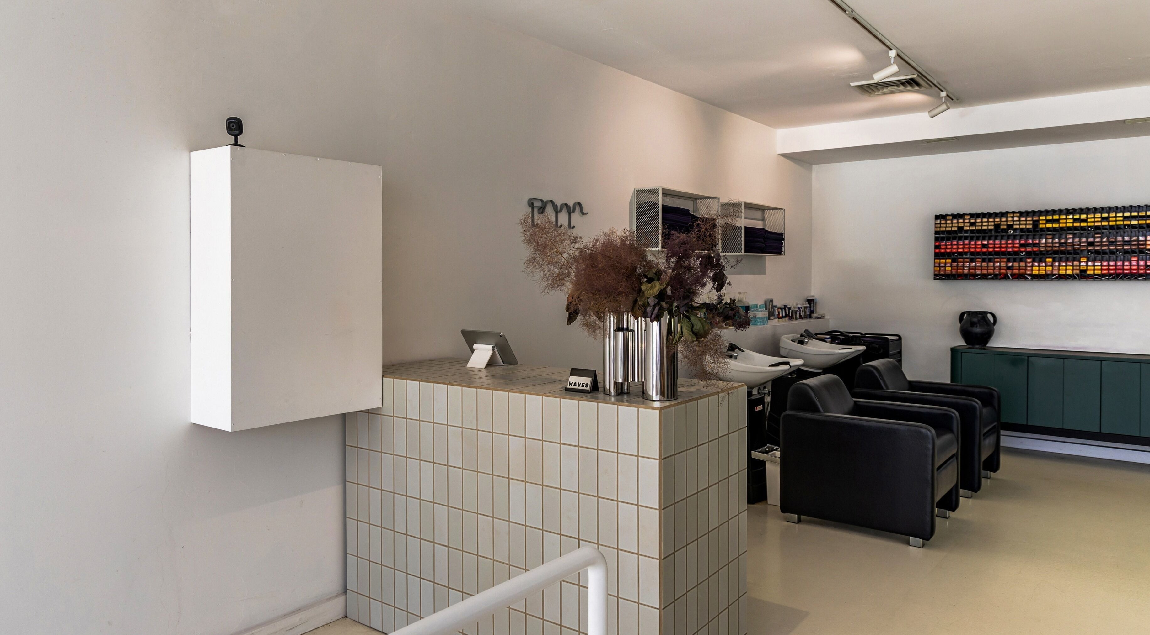 Modern salon interior at WAVES in Melbourne, Victoria, AU, featuring sleek chairs and stylish decor.