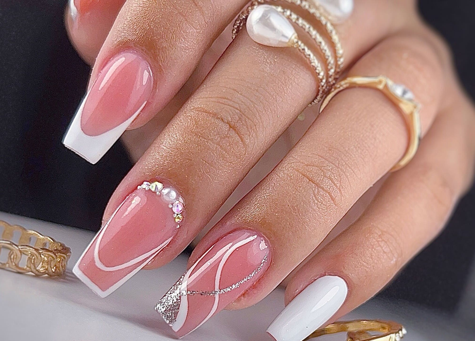 Manicura francesa elegante en Yoss Nails, Memphis, Tennessee, US. Diseños con perlas y líneas artísticas.