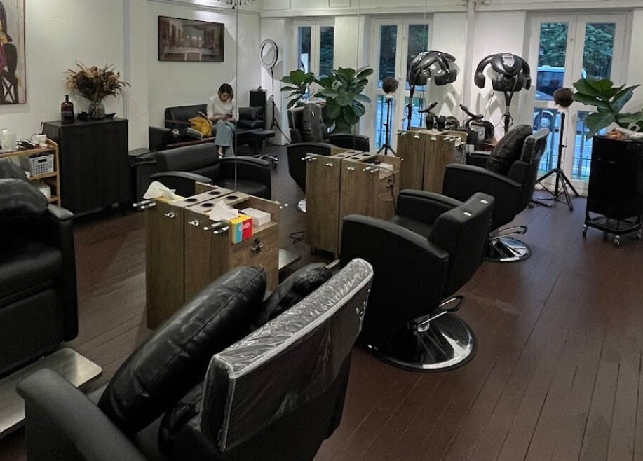 Modern salon interior at Hair Eclipse, Singapore, SG, featuring sleek chairs and stylish decor.