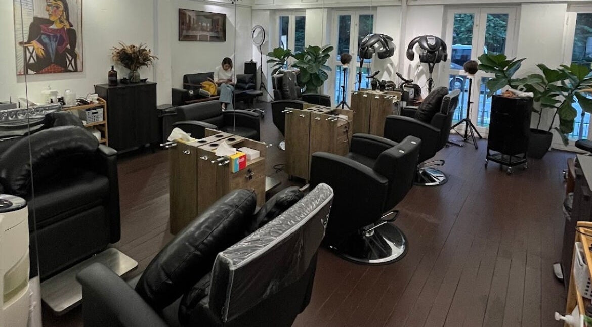 Modern salon interior at Hair Eclipse, Singapore, SG, featuring sleek chairs and stylish decor.