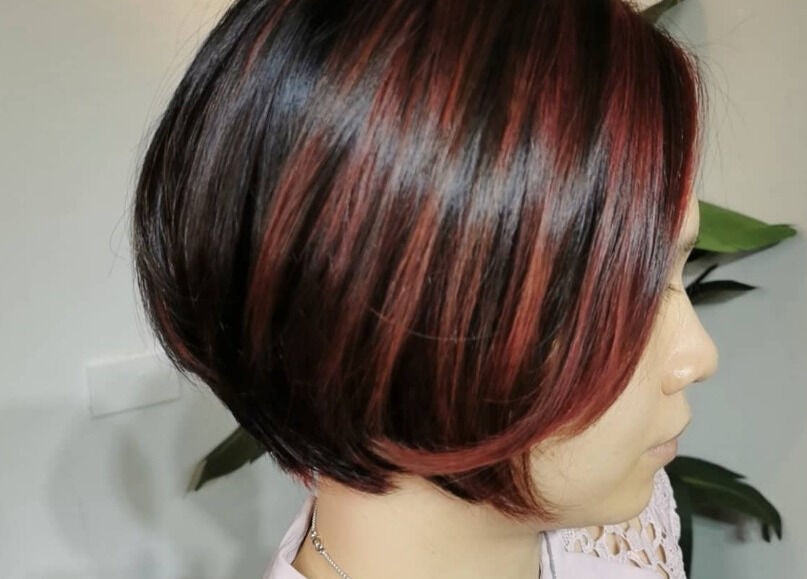 Elegant short hairstyle with red highlights at Hair Eclipse, Singapore, Singapore, SG.