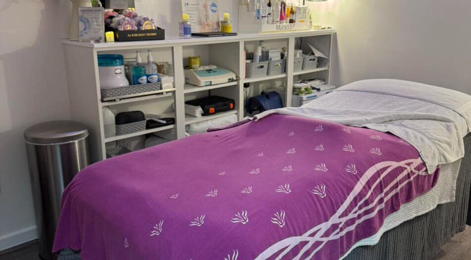 Cozy treatment bed at Pennyfeathers, Saint Saviour, GB, adorned with a purple blanket for relaxation.
