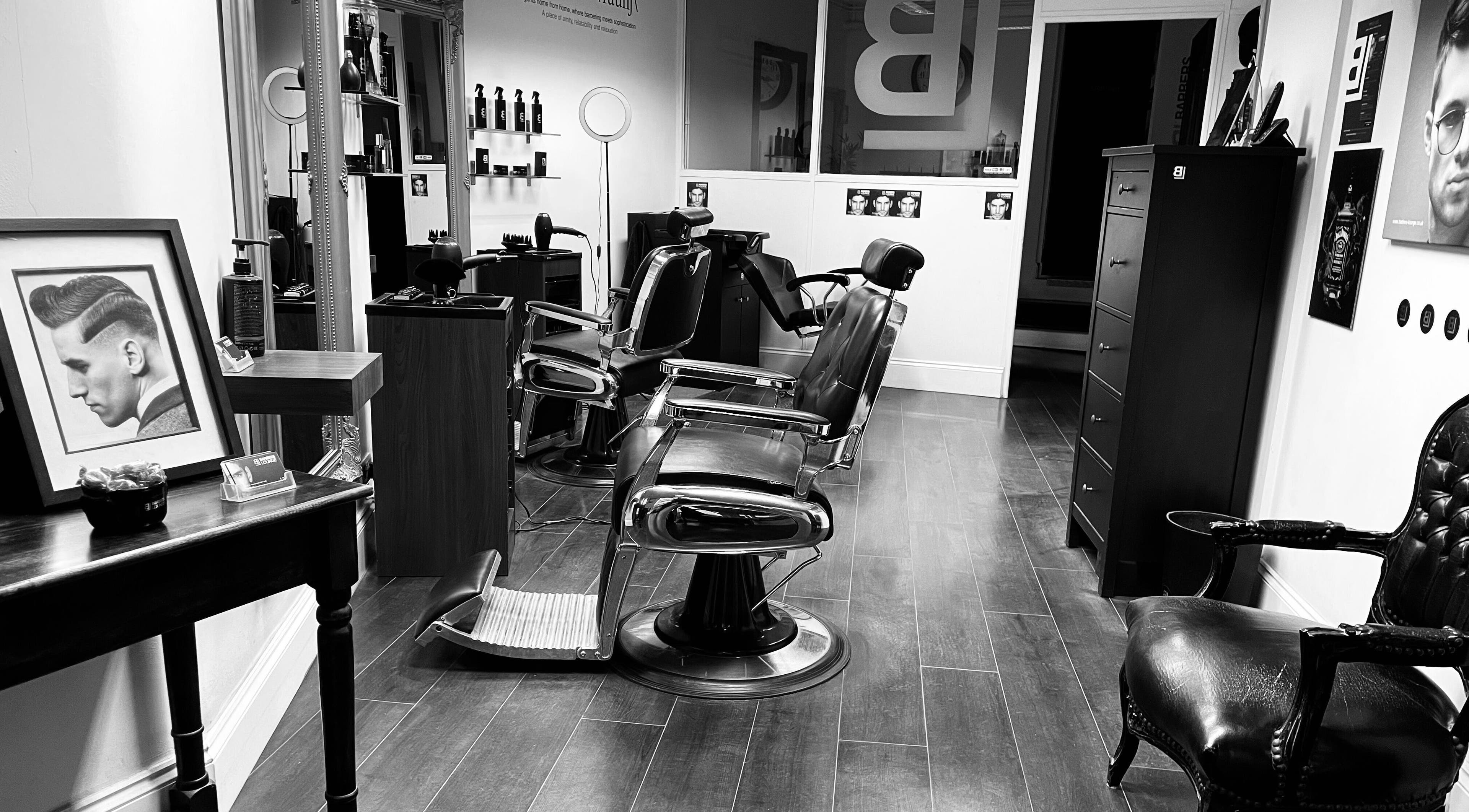 Interior of BL Barbers Lounge with vintage chairs and stylish decor in Macclesfield, England, GB.