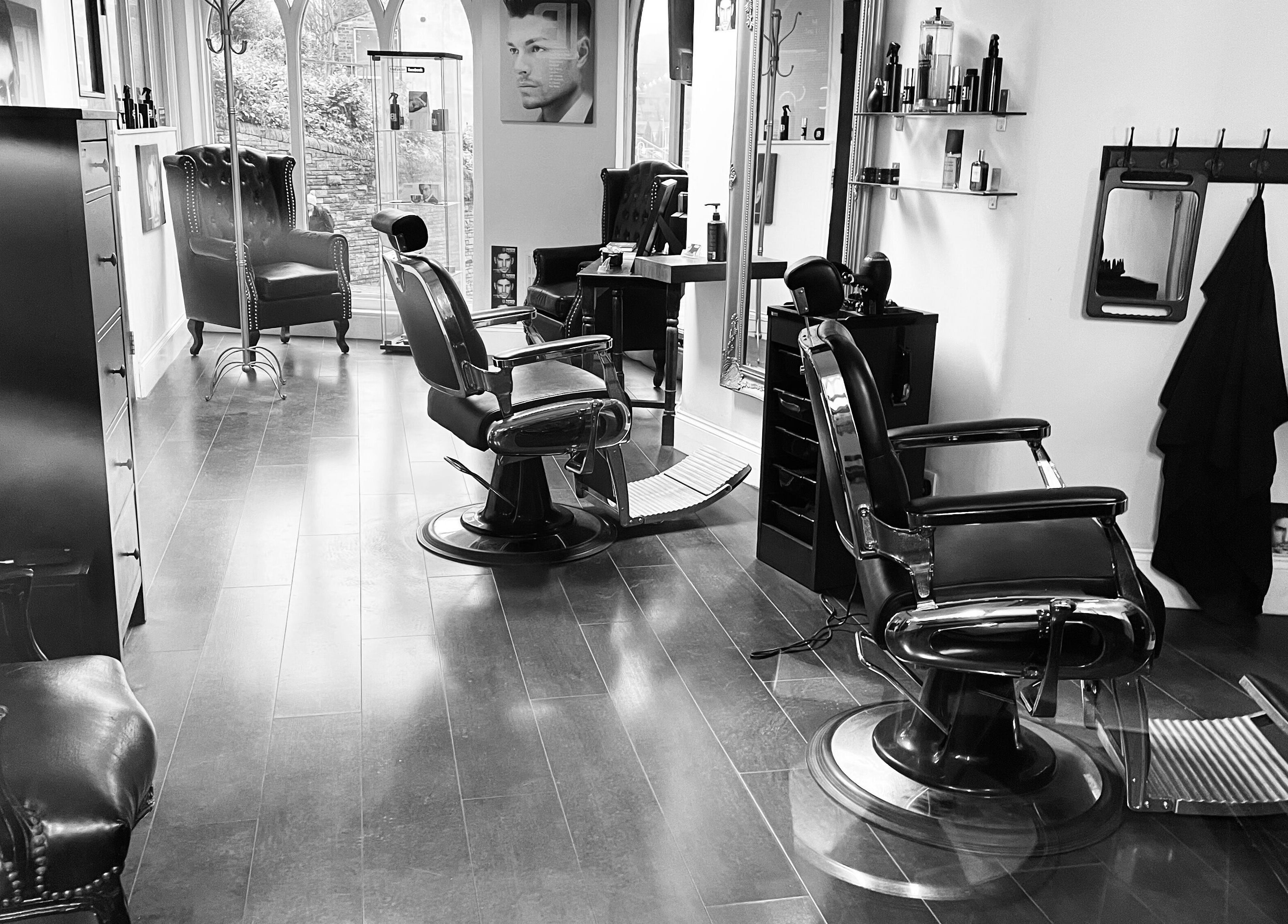 Stylish interior of BL Barbers Lounge, Macclesfield, England, GB with leather chairs and sleek decor.