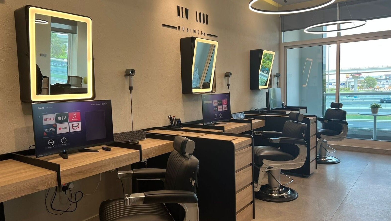 Modern salon interior at New Look Business, Dubai, Dubai, AE, featuring stylish workstations and mirrors.