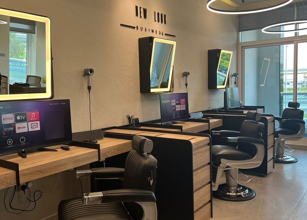 Modern salon interior at New Look Business, Dubai, Dubai, AE, featuring stylish workstations and mirrors.